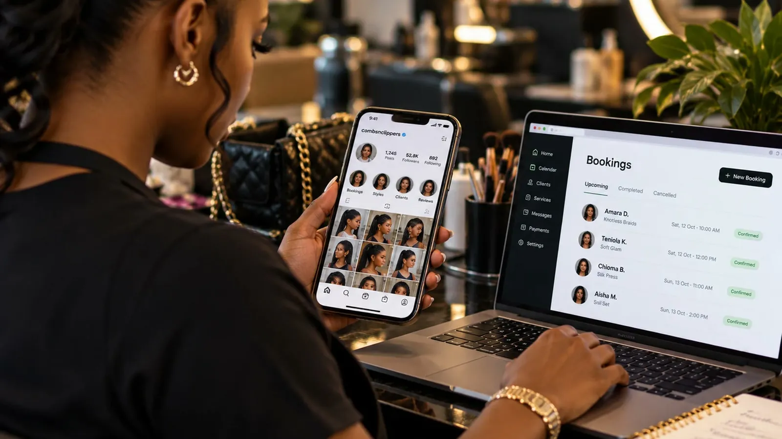 Hair stylist looking at a social media profile on her phone while a bookings dashboard with upcoming appointments is open on her laptop.